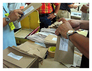 sealed envelopes containing local absentee votes which were cast a few days ago by people who wouldn't be able to vote today because they would be on duty (like policemen, and teachers  who were assigned poll duty today)